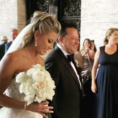 They are standing next to each other and both of them looking down.